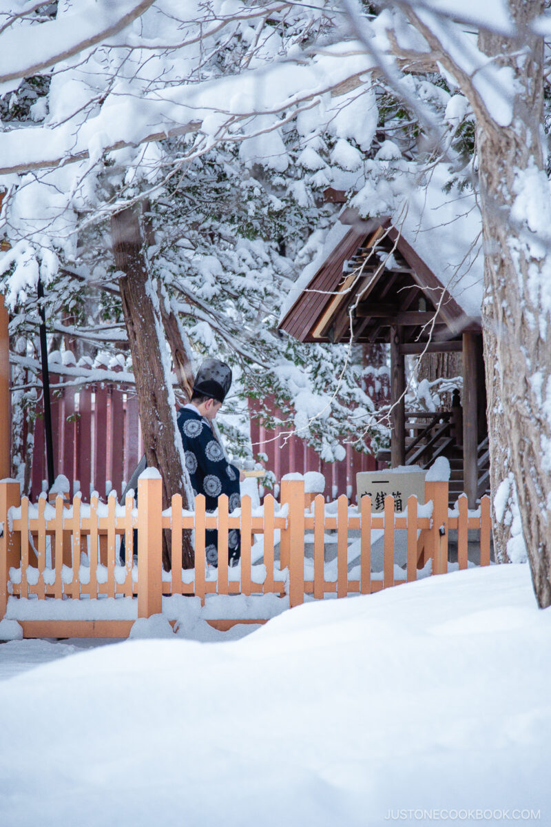 Priest praying at a shrine in Hokkaido Jingu