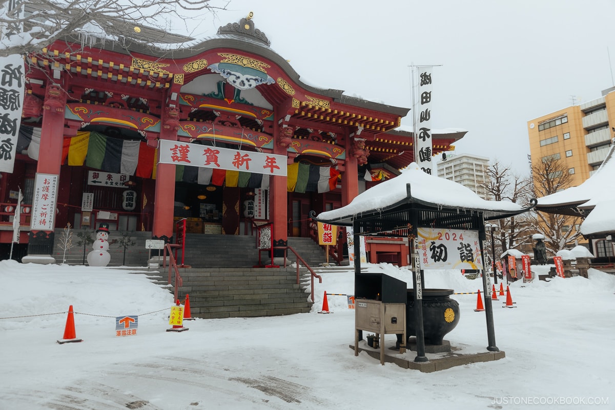 Temple and incense burner covered in snow