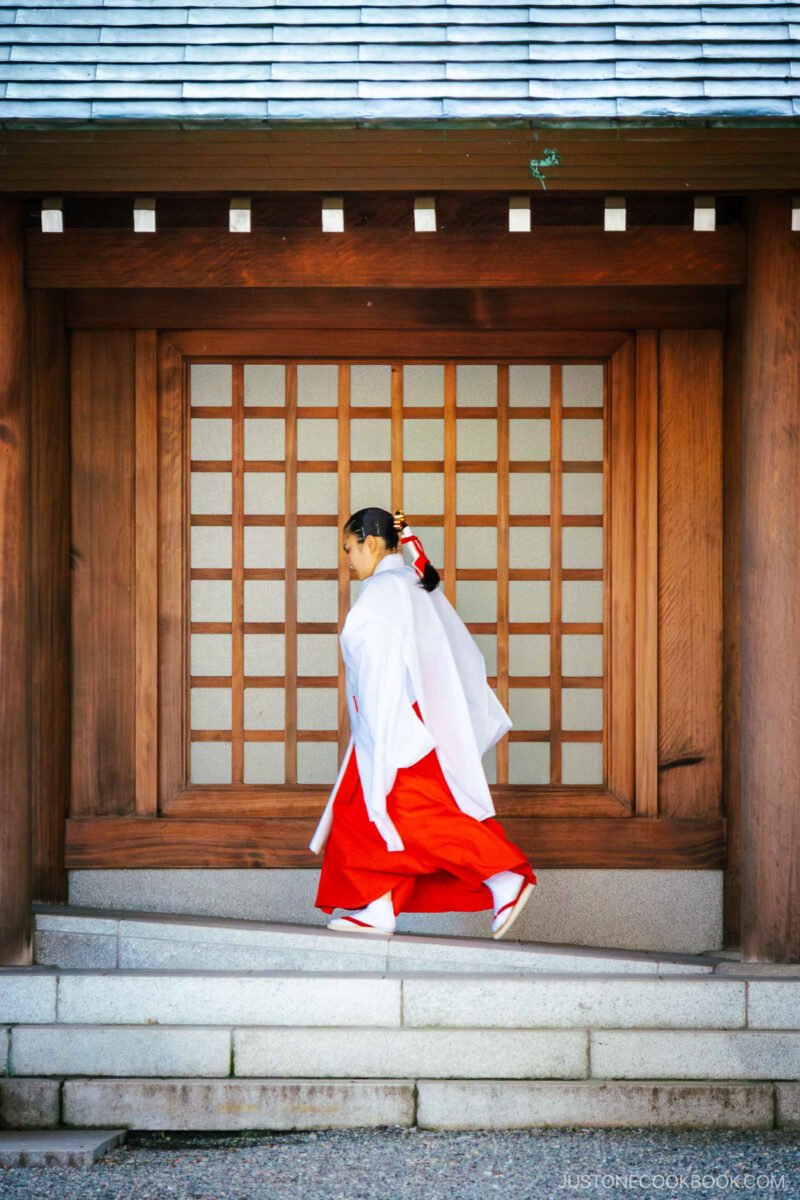 Shrine maiden walking through Hokkaido Shrine