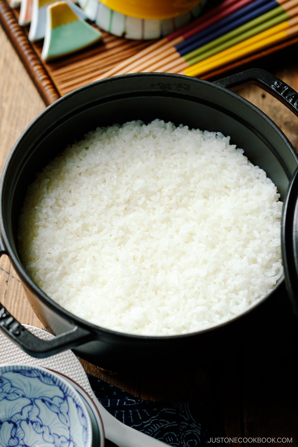 A black Staub containing perfectly cooked Japanese short-grain rice.