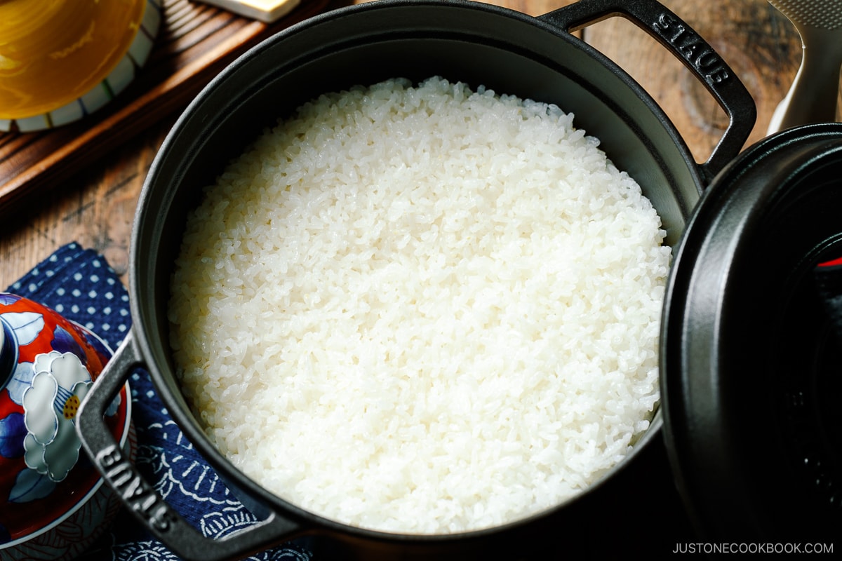 A black Staub containing perfectly cooked Japanese short-grain rice.