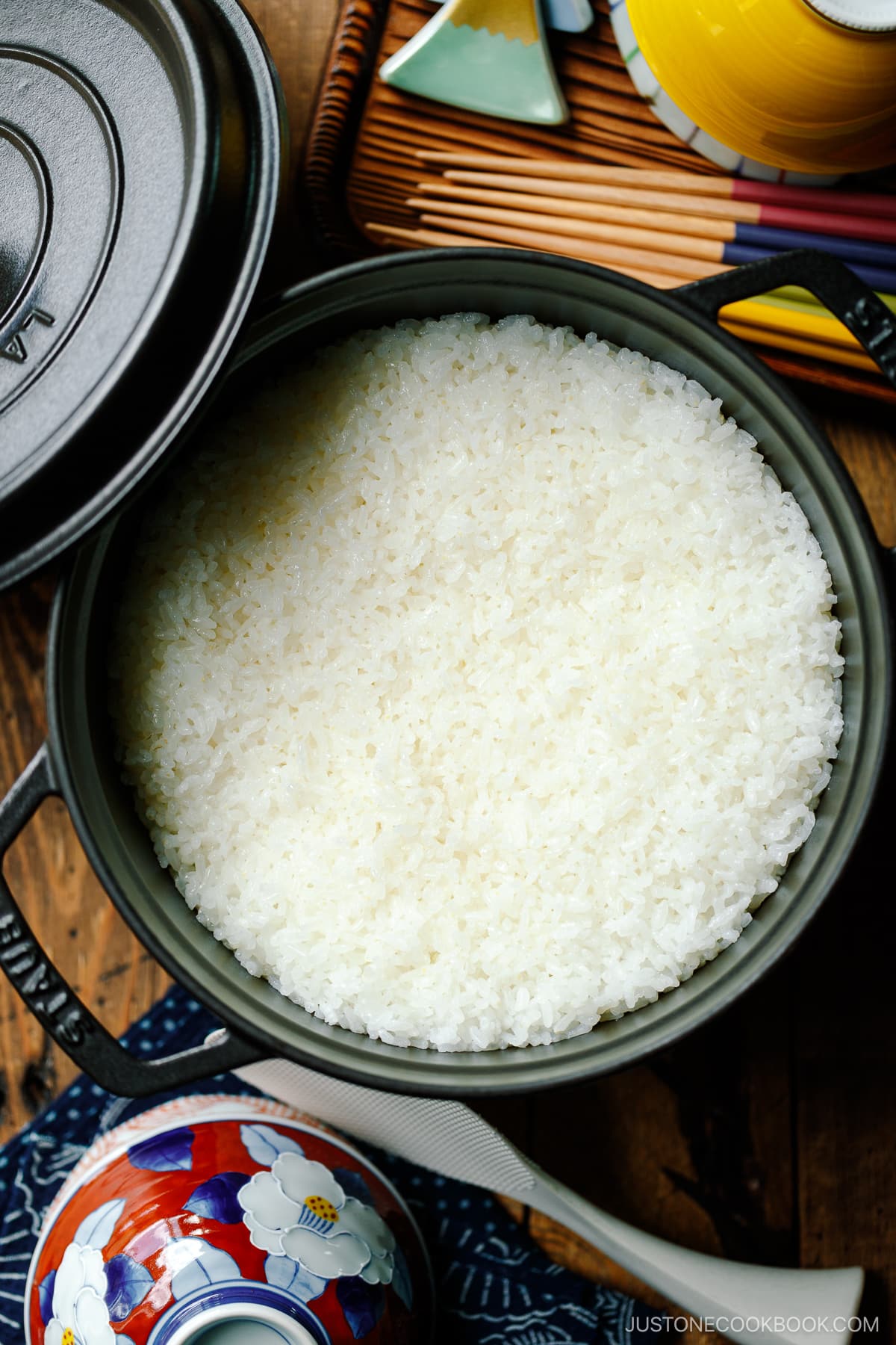 A black Staub containing perfectly cooked Japanese short-grain rice.