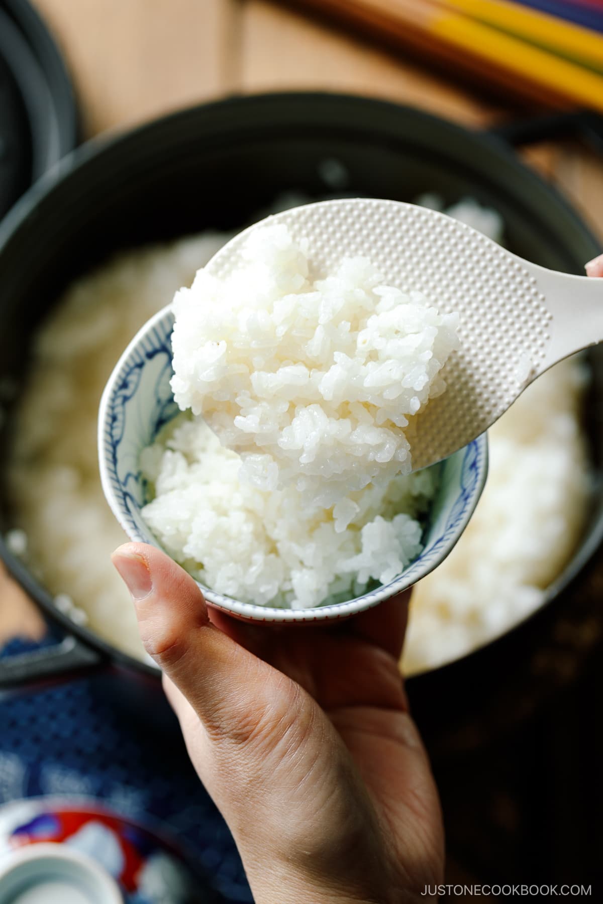 Perfectly cooked Japanese short-grain rice being served in the Japanese rice bowl.