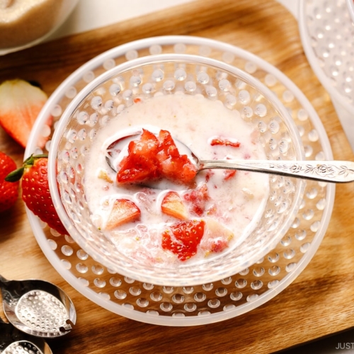 A glass bowl containing Showa-style Japanese strawberry milk called Ichigo Milk.