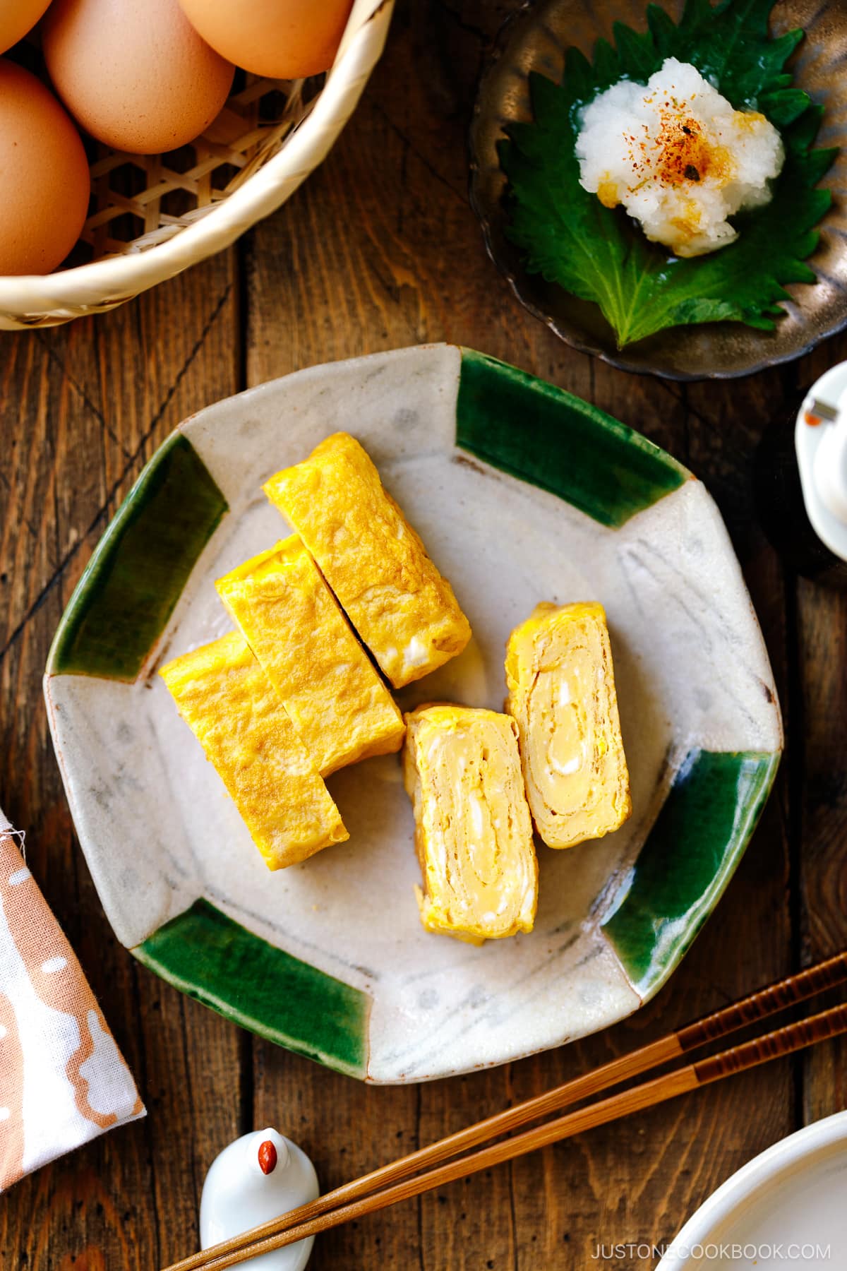 A Japanese ceramic plate containing Japanese rolled omelette, Tamagoyaki.