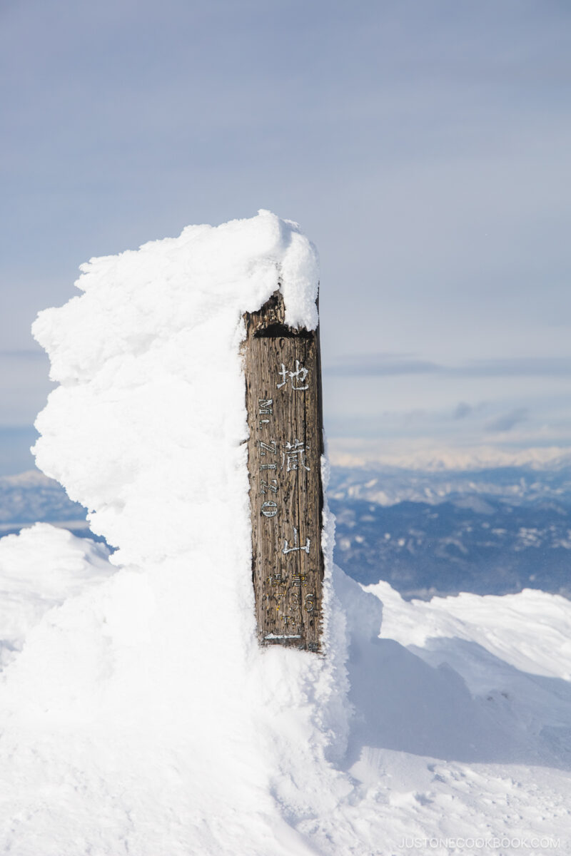 Wooden sign covered in snow