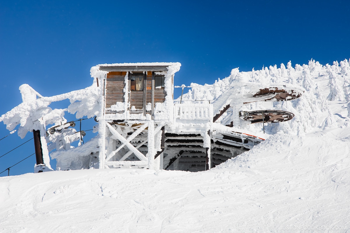 Wooden gondola lift covered in snow
