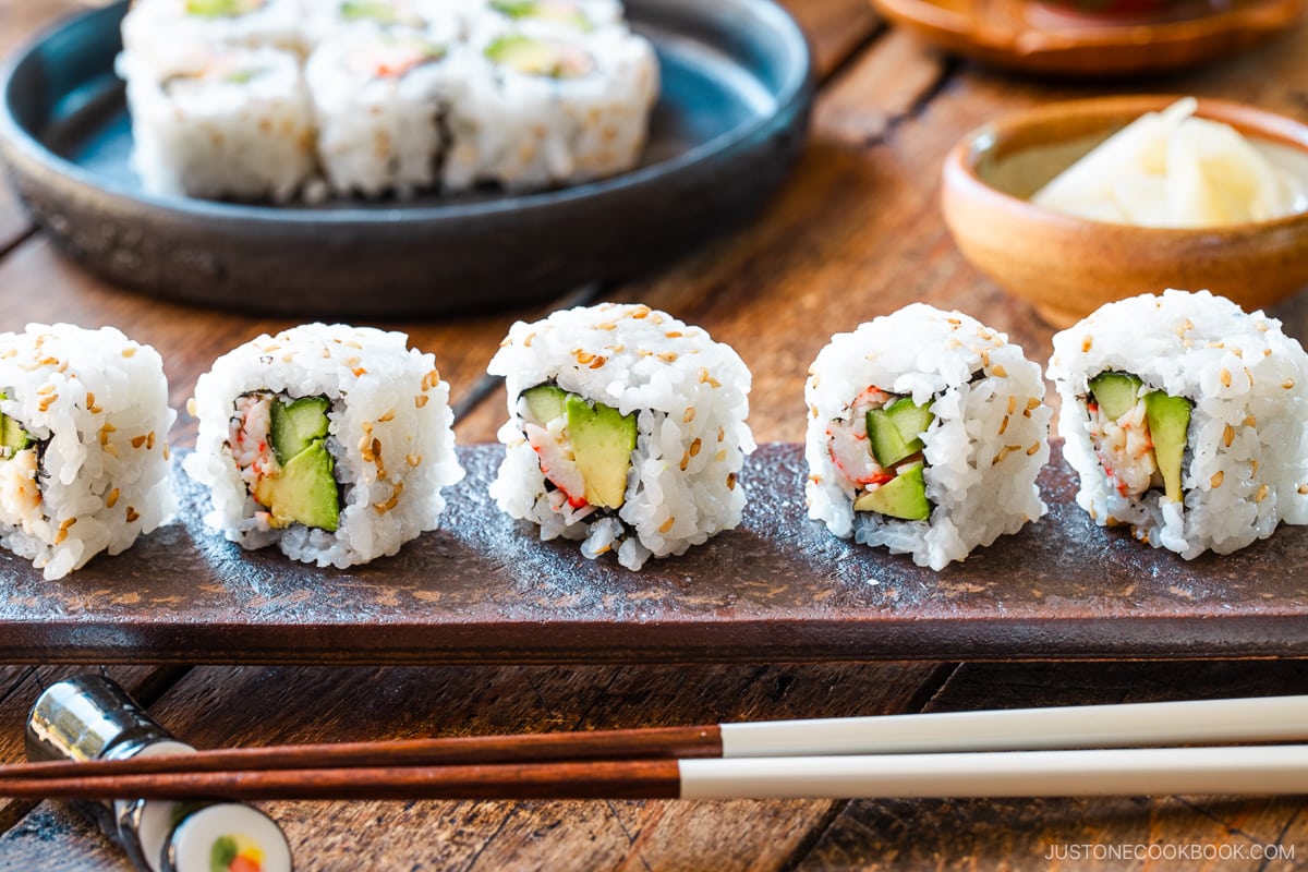 A long rectangular plate containing California Rolls.