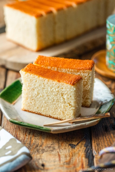 An octagon plate containing two slices of Castella cake.