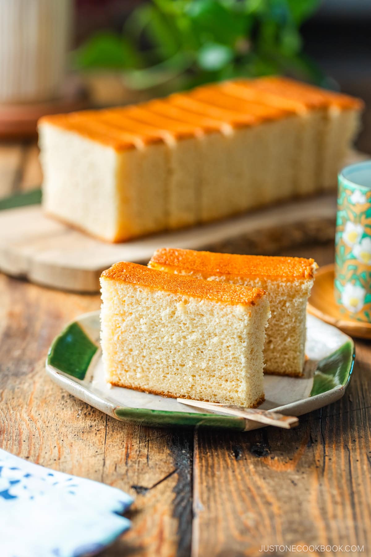 An octagon plate containing two slices of Castella cake.