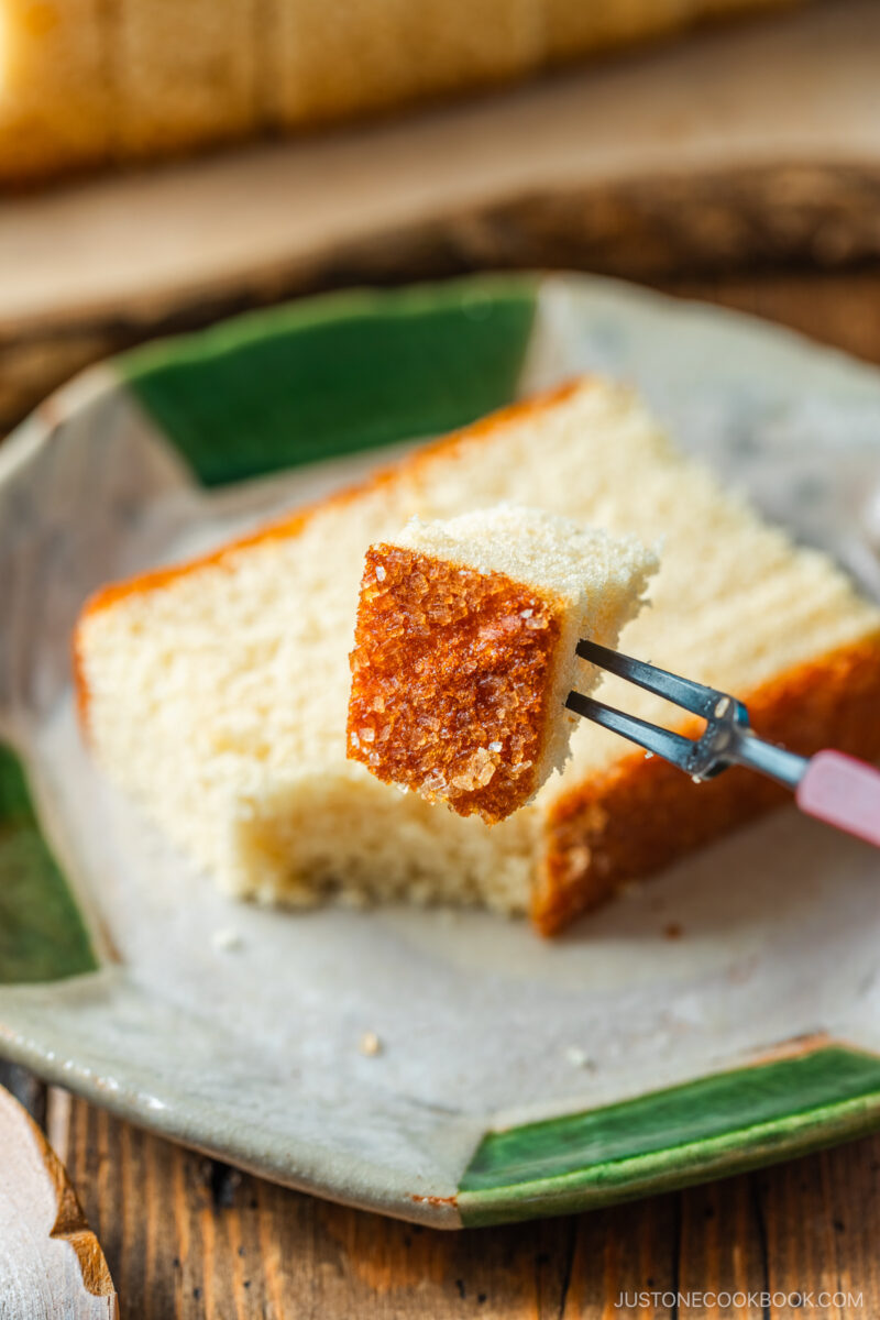 An octagon plate containing a slice of Castella cake.