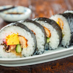 An oval plate containing Futomaki (Thick Maki Sushi).