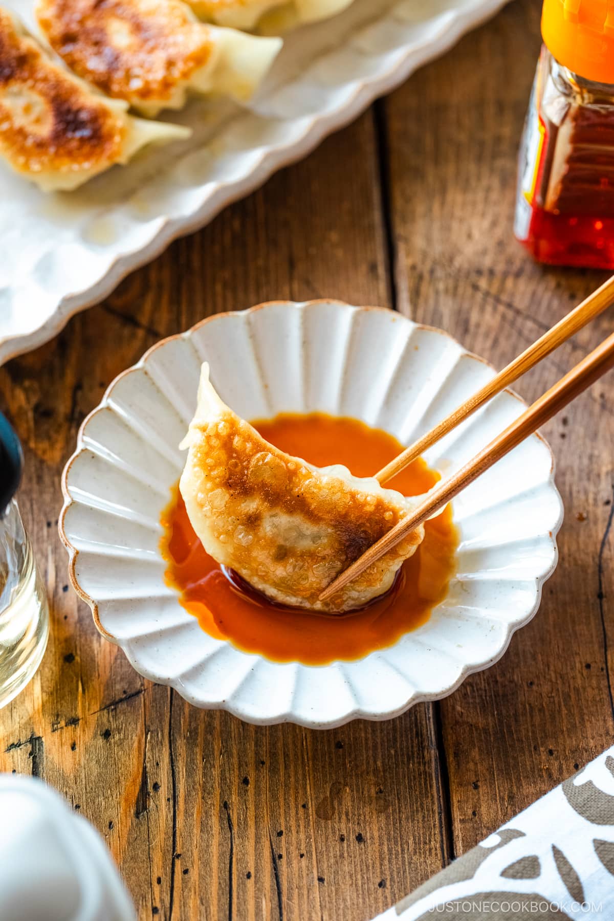 Gyoza in dipping sauce made with soy sauce, vinegar, and Japanese chili oil.