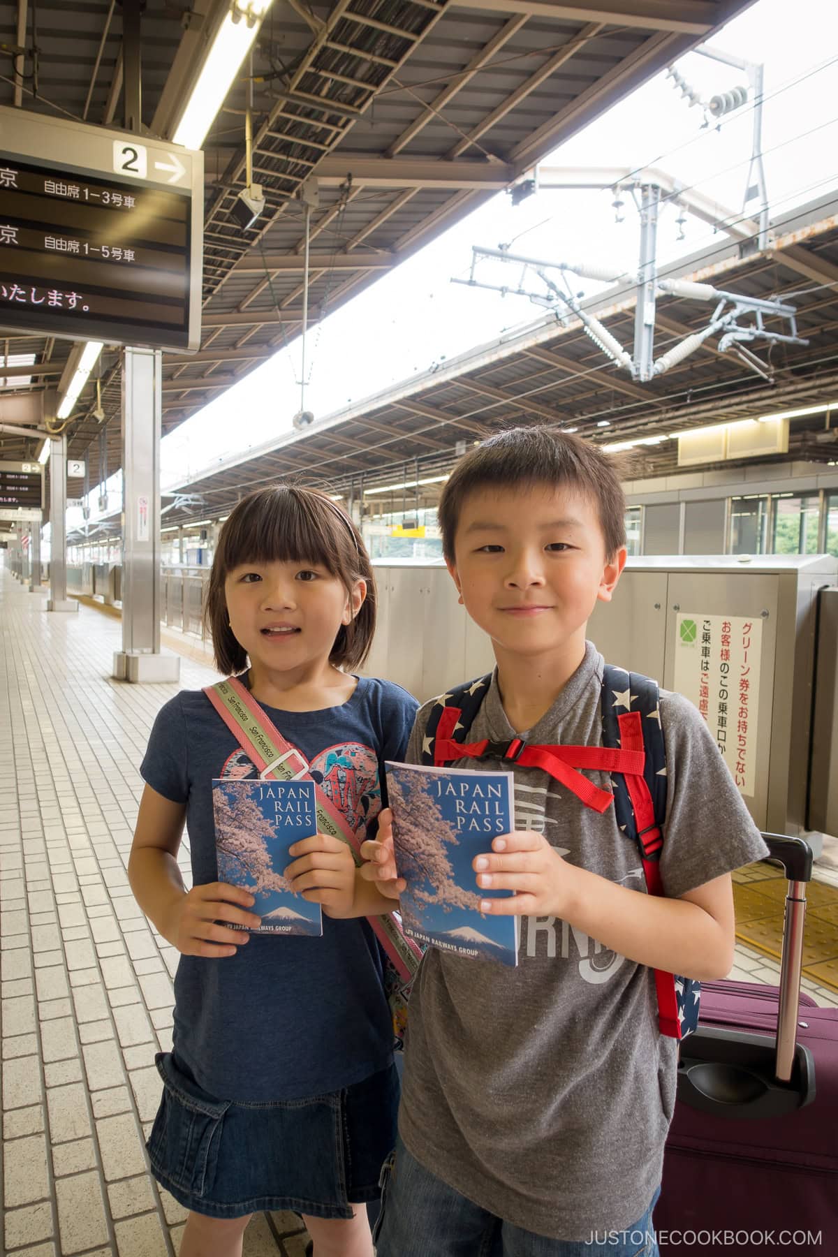a boy and a girl holding JR Pass