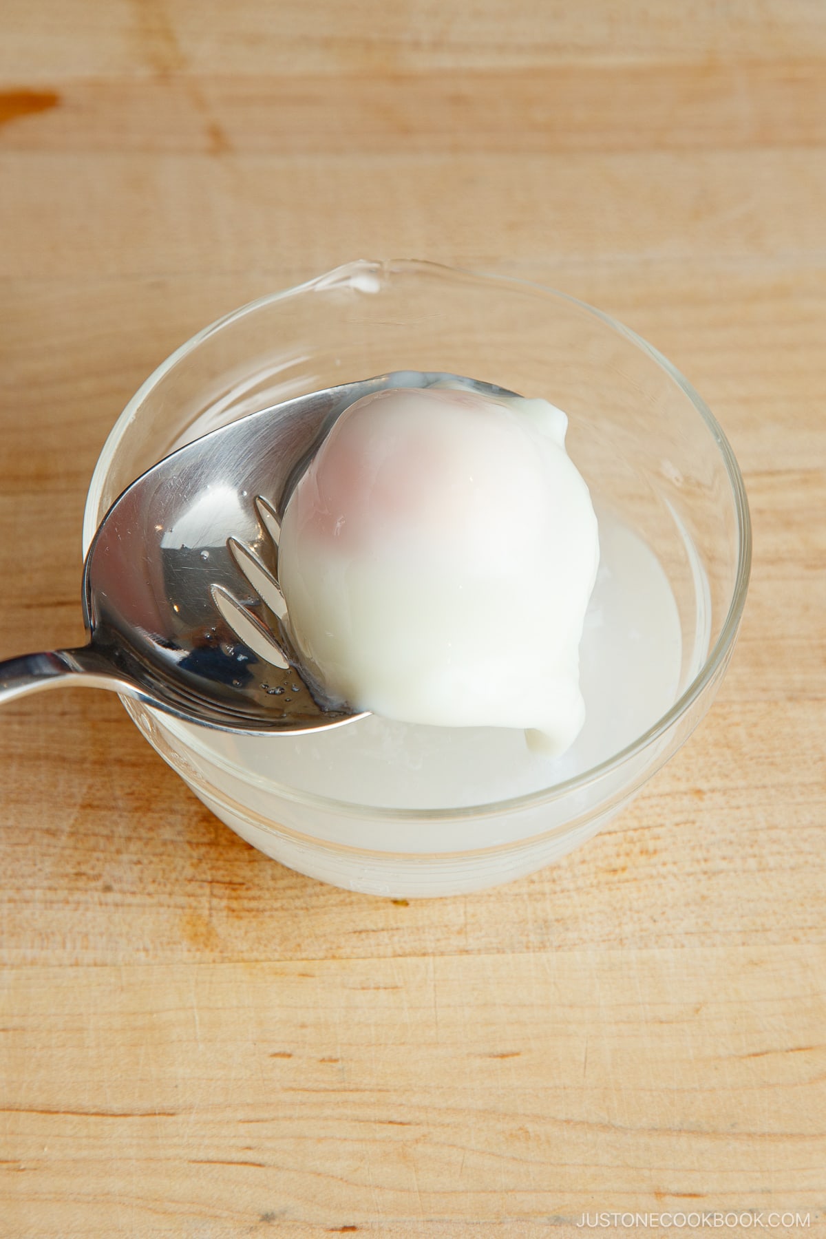 A plate containing Onsen Tamago (Japanese hot spring egg) made with a microwave.