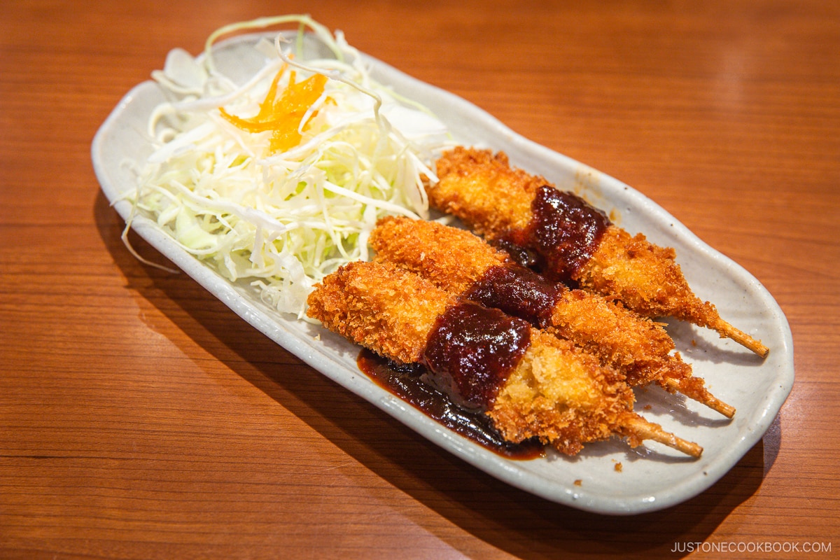 Deep fried fillet on skewers topped with red miso sauce