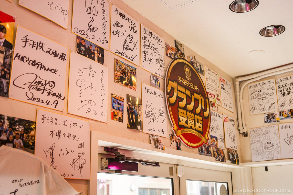Autographs of famous personalities on a shop wall
