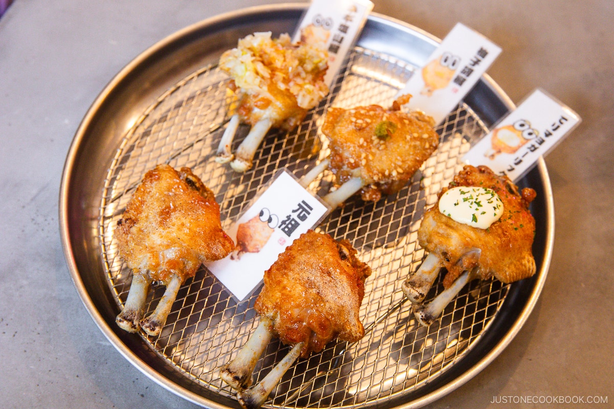 Different flavors of chicken wings on a silver plate