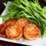 A square white plate contaning Sauteed Yam, which is simply cooked in a frying pan and coated with soy sauce.