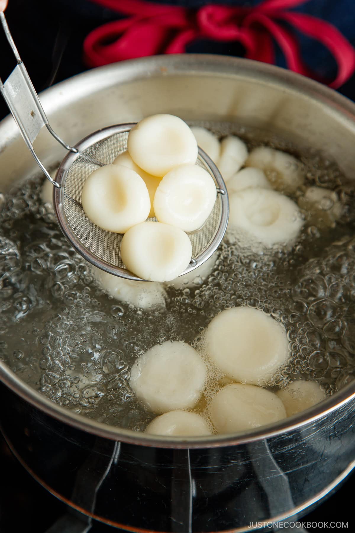 Shiratama dango (mochi balls) being cooked in a boiling water.