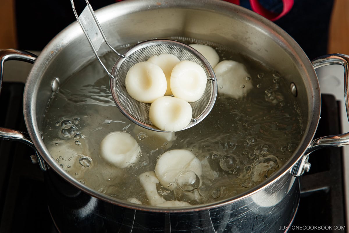 Shiratama dango (mochi balls) being cooked in a boiling water.