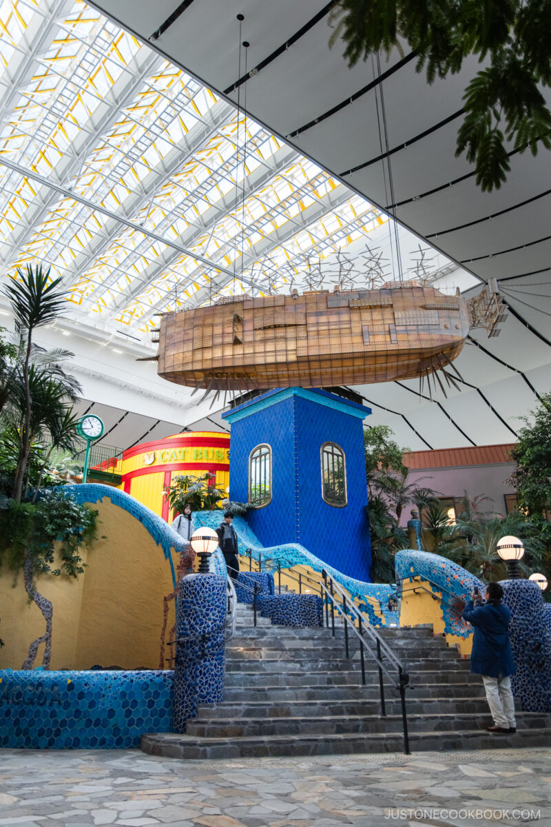 Mozaic tile staircase with wooden boat hanging from the ceiling