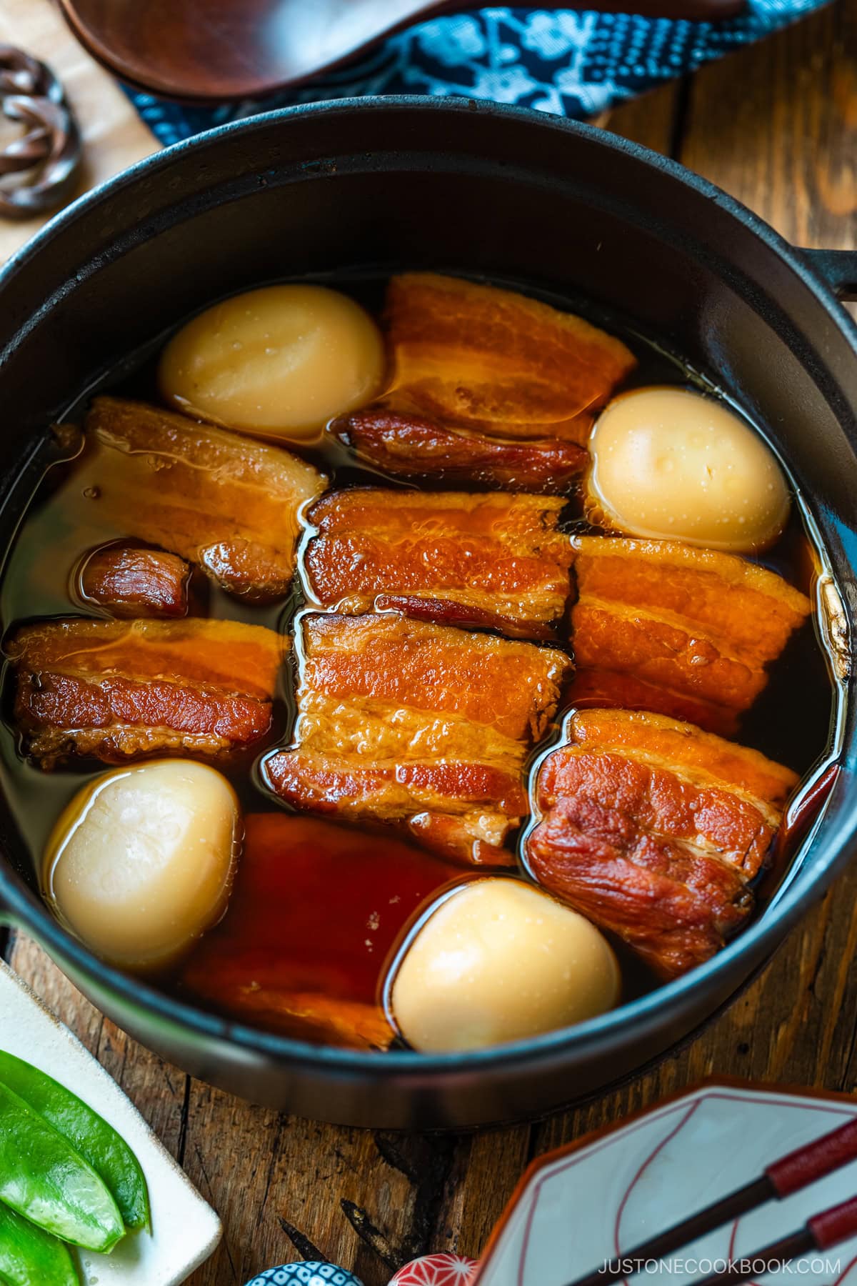 A Staub containing Kakuni, Japanese braised pork belly, sitting in a sweet and savory sauce.