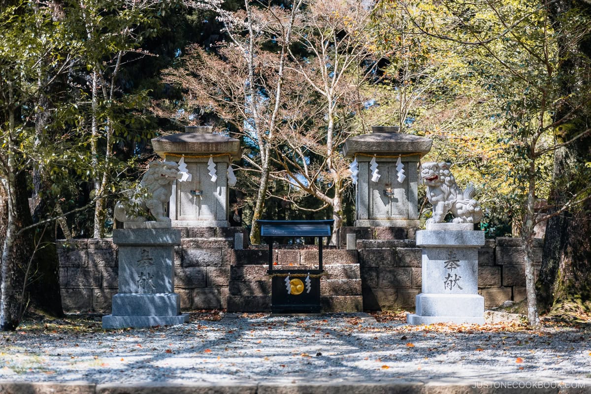 Stone shrine under cherry blossom trees