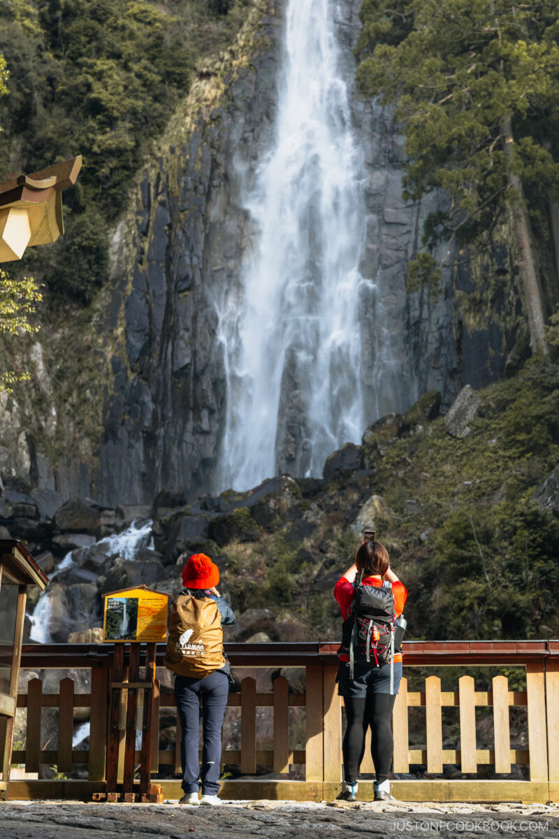 Two people taking a photo of Nachi waterfall