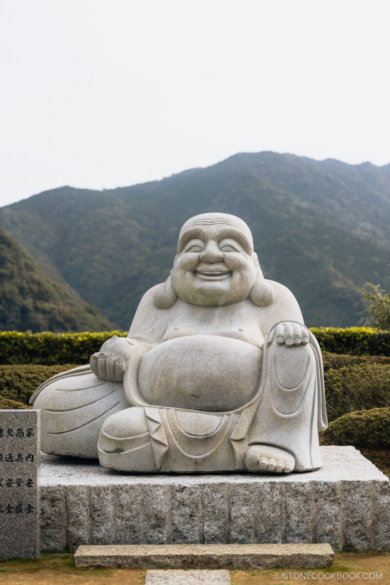 Stone statue of smiling monk