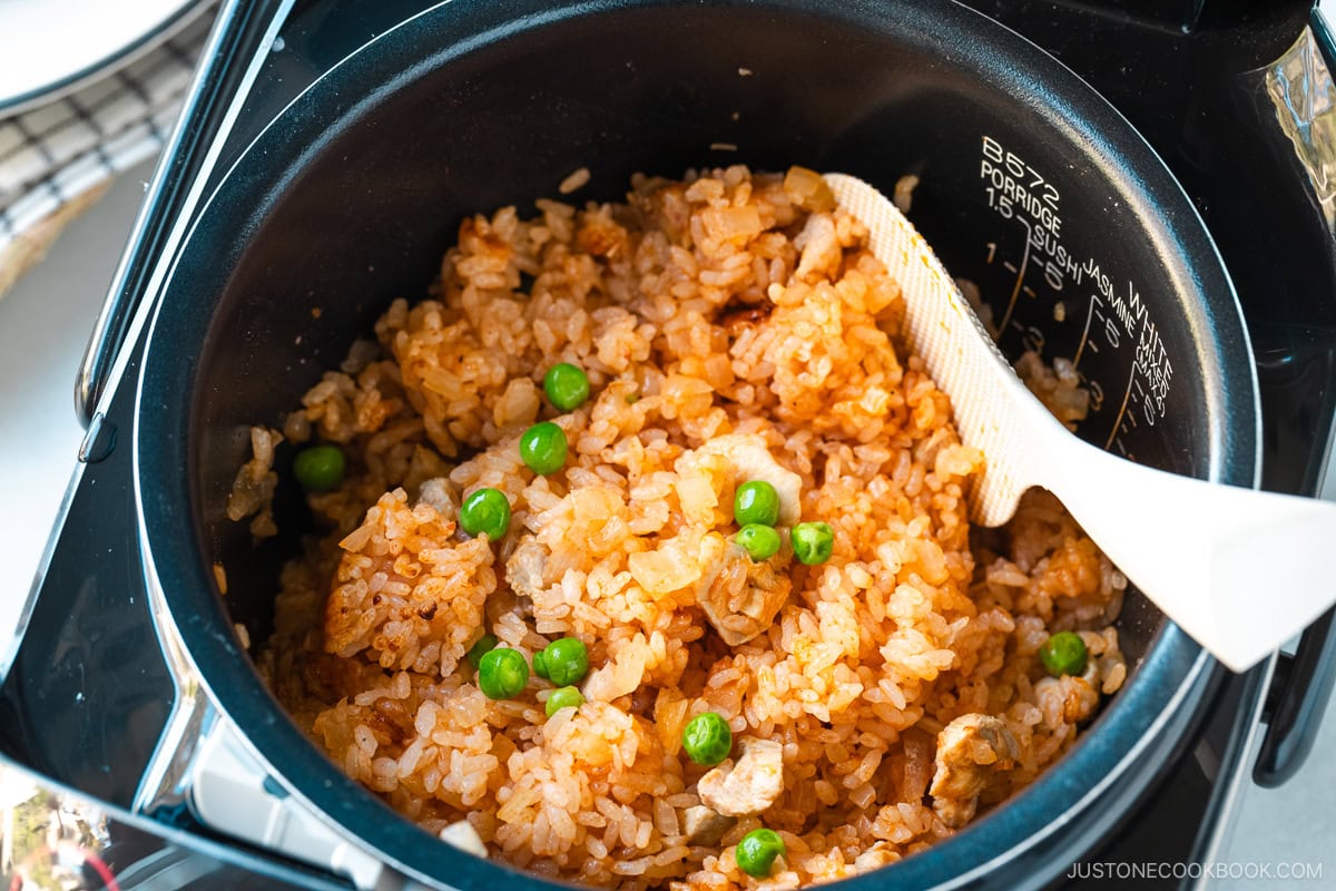 A rice cooker containing Chicken Rice, seasoned with Japanese ketchup and Worcestershire sauce.