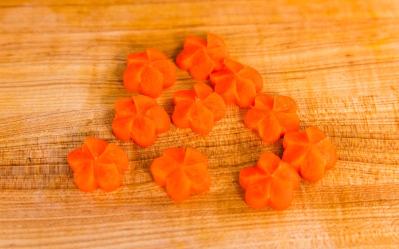Carrot coins carved into Japanese ume plum shapes.