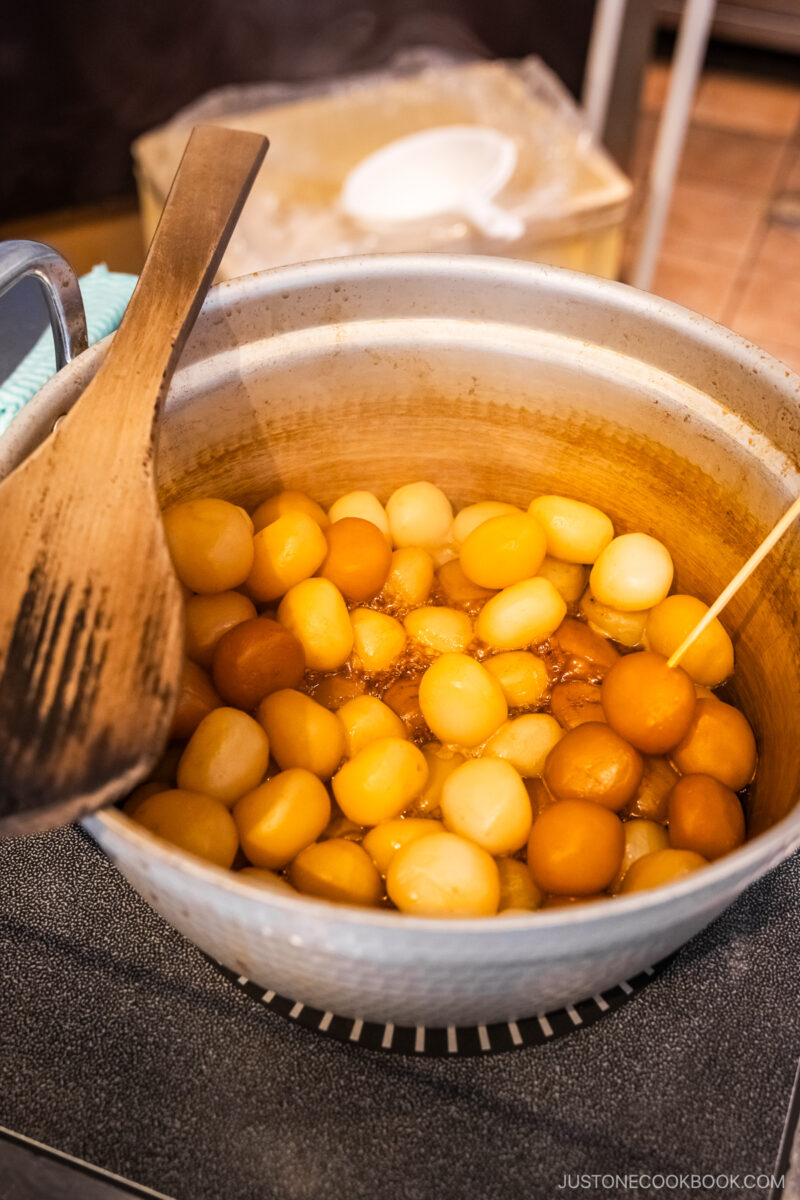 Pot of konnyaku balls simmering in a soy sauce based broth