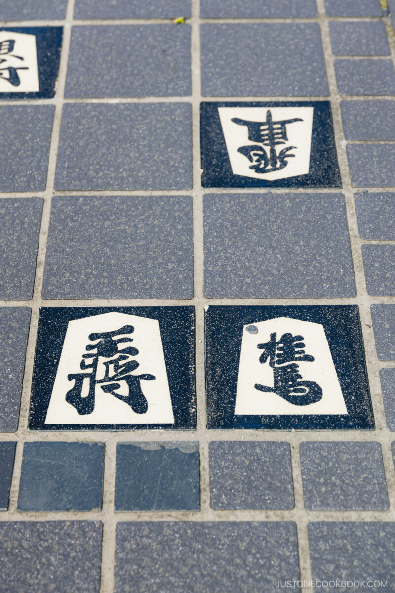 Shogi koma engravings on a sidewalk