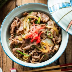A donburi rice bowl containing gyudon, simmered beef and onions over steamed rice.