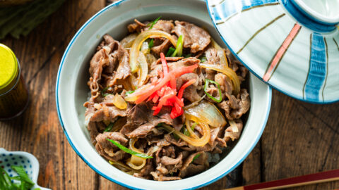 A donburi rice bowl containing gyudon, simmered beef and onions over steamed rice.