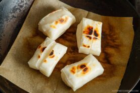Toasting kiri mochi (Japanese rice cakes) in a frying pan.