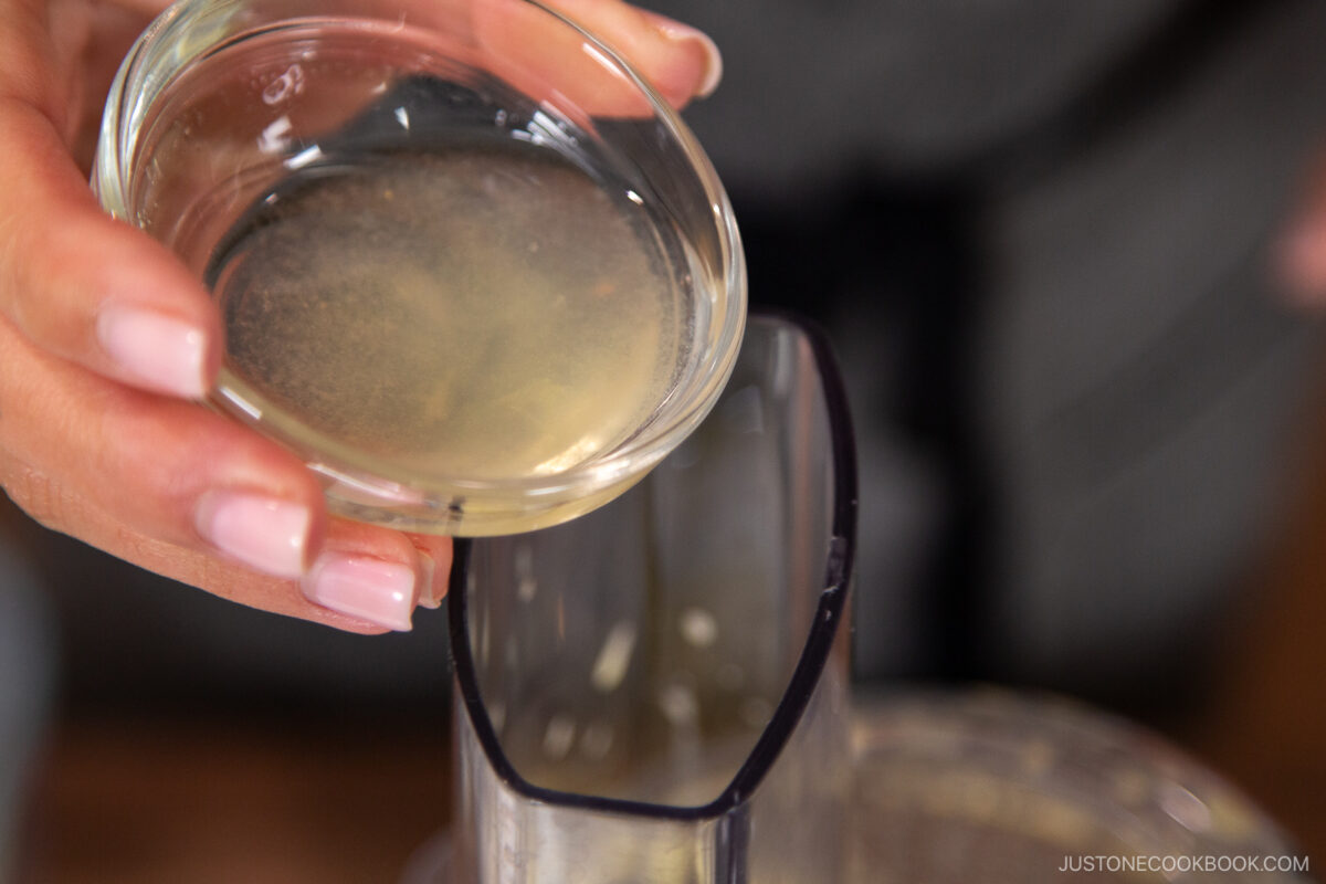 Add the rice vinegar, lemon juice, and remaining oil. Process for an extra 10 seconds, just until the ingredients are combined and emulsified.