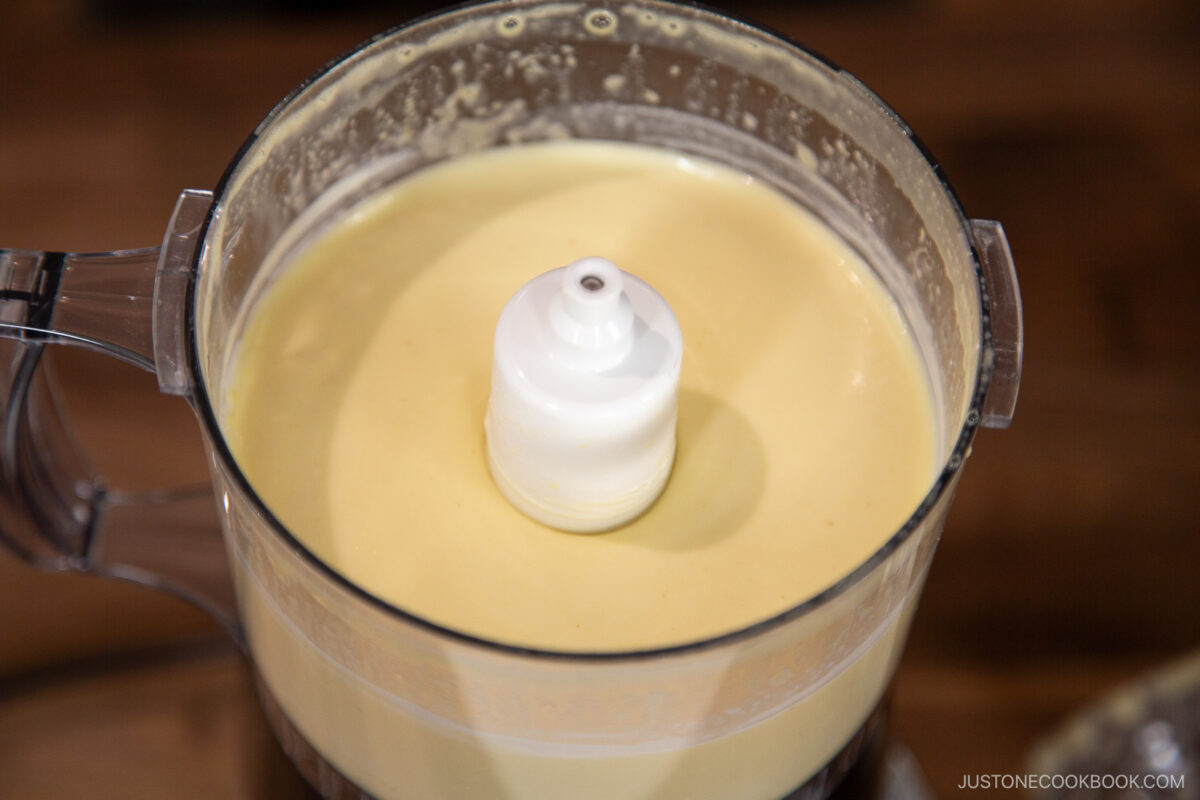 Add the rice vinegar, lemon juice, and remaining oil. Process for an extra 10 seconds, just until the ingredients are combined and emulsified.