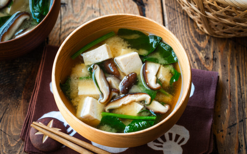Wooden soup bowls containing Spinach and Mushroom Miso Soup.