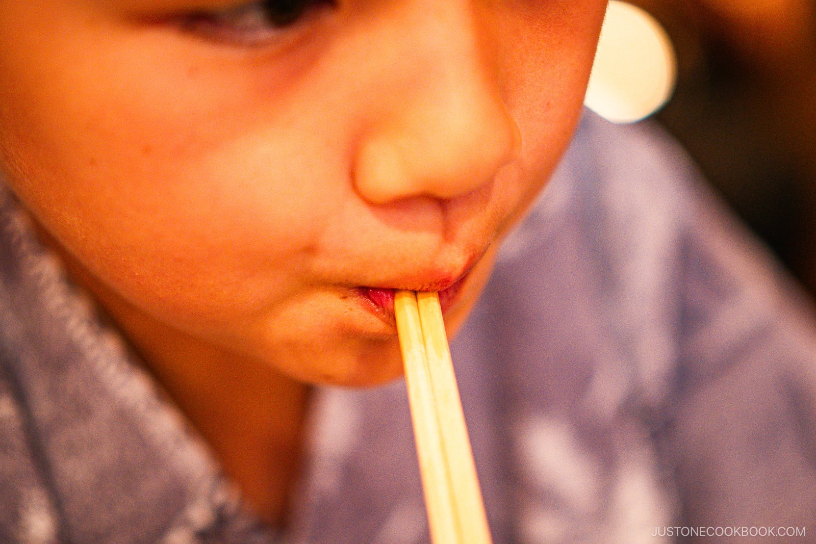 Chewing or licking chopsticks acceptable manner?