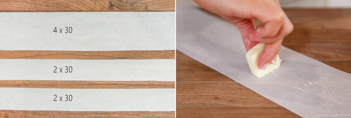 Two strips of parchment paper marked 4 x 30 and 2 x 30 are on a wooden surface, next to a hand gently rubbing butter onto another strip—prepping the perfect base for a soft Japanese Cheesecake.