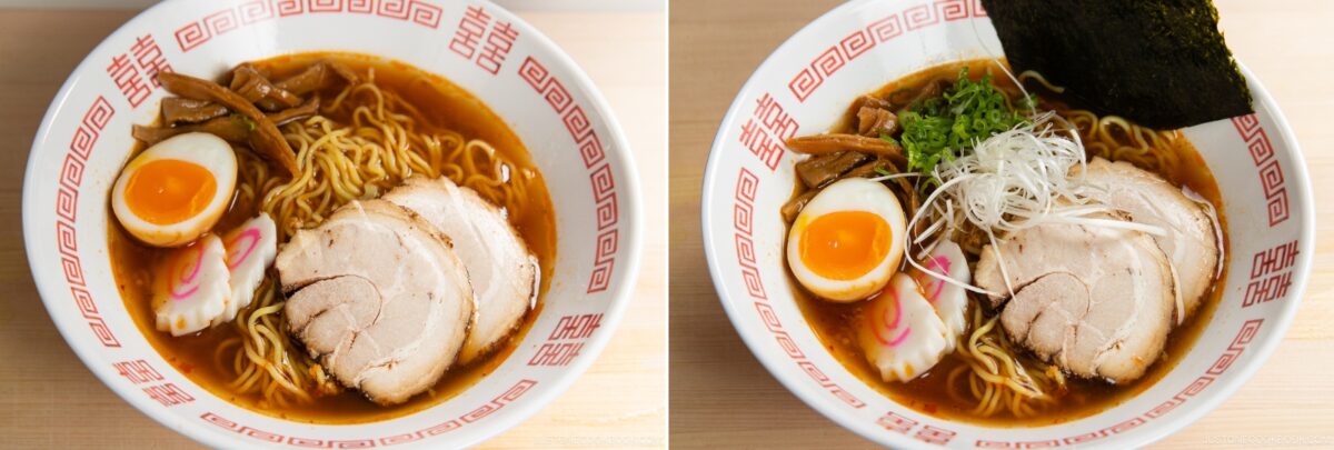 Two bowls of spicy shoyu ramen with sliced pork, soft-boiled egg, bamboo shoots, and fish cake; the right bowl features green onions, shredded white onions, and nori seaweed. Both are served in patterned bowls on a wooden surface.