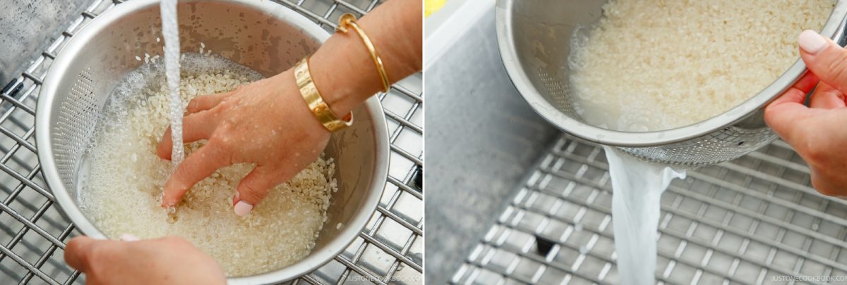 Hands rinse white rice in a metal colander under running water before draining it, a key step when learning how to cook rice in a donabe.