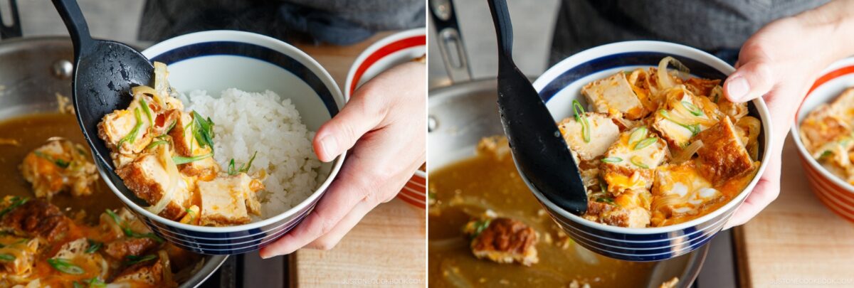 A person uses a black ladle to scoop a mixture of katsu, egg, and vegetables over a bowl of white rice, preparing a Japanese rice bowl dish. The food is served from a pan into a striped bowl.