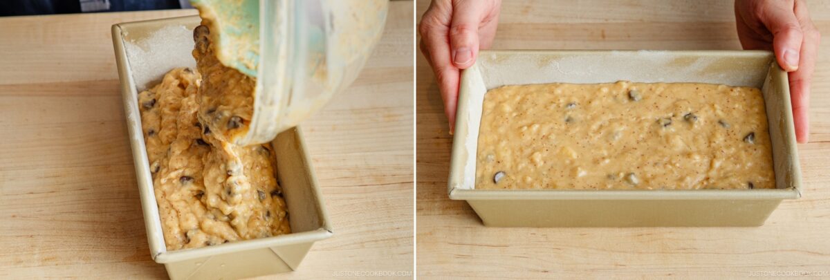 A person pours chunky Brown Butter Banana Bread batter with chocolate chips into a loaf pan, then smooths the surface with their hands holding the pan on a wooden countertop.
