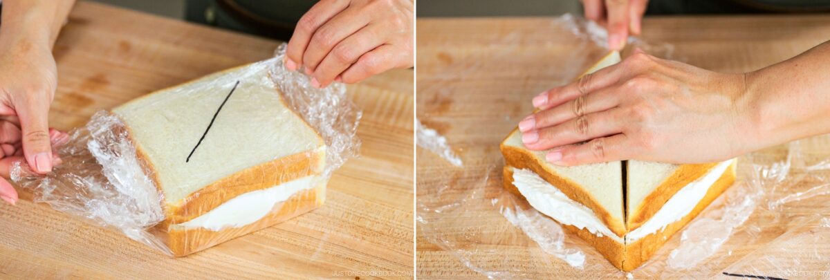 Two photos show hands wrapping a Japanese Fruit Sandwich with whipped cream filling in plastic wrap, then slicing it in half while still wrapped. The sandwich rests on a wooden surface.