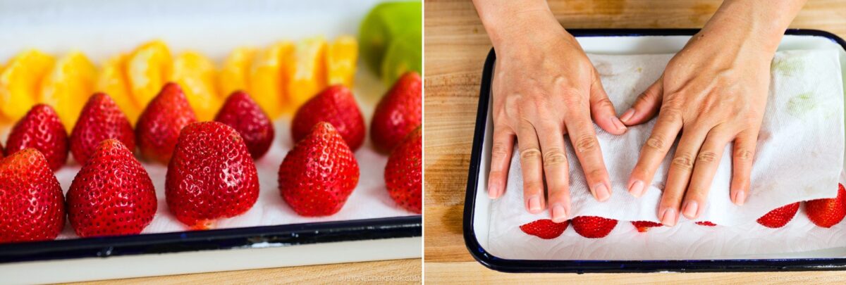Fresh strawberries and orange slices on a paper towel in a tray; hands gently pressing a paper towel over the strawberries to dry them—perfect prep for a delightful Japanese Fruit Sandwich.