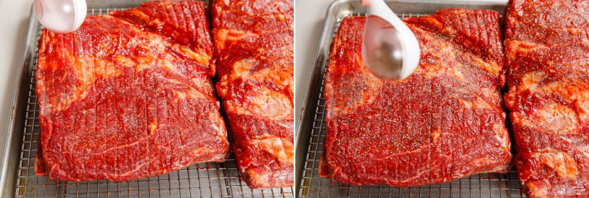 Side-by-side images show raw, seasoned beef brisket on a wire rack. In the first, a spoon hovers over the meat; in the second, pepper is sprinkled—perfect prep inspiration for smoked beef ribs or other barbecue favorites.