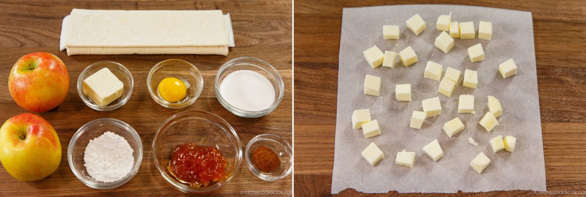 Easy Apple Tart ingredients are ready: two apples, butter, an egg yolk, sugar, flour, jam, cinnamon, and puff pastry on a wooden surface; next to cubed butter on parchment paper.